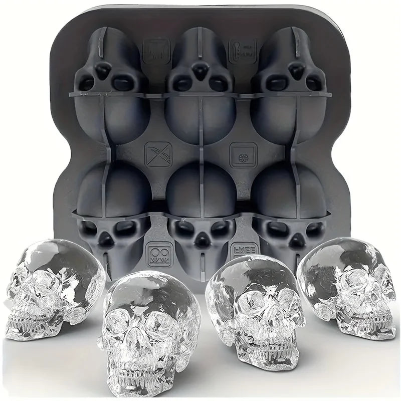 A set of silicone skull ice cube molds in black and clear glass, shown with a mold tray.