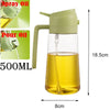 A clear glass oil spray bottle with a green pump dispenser and a yellow liquid, shown next to size measurements.