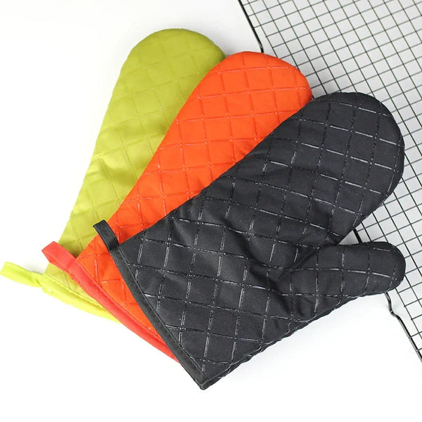 Three silicone printed non-slip oven mitts in lime green, orange, and black are displayed on a wire grid.