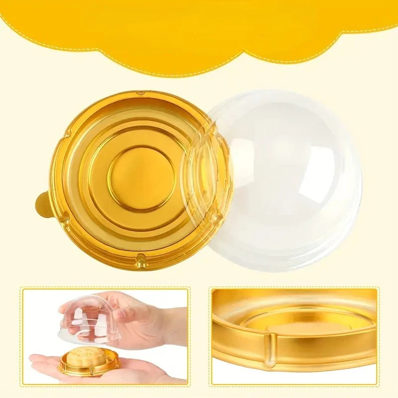 A set of mini transparent cake boxes and a gold lid for pastries.