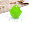 A bright green silicone egg poacher mold is shown on a light brown mat.