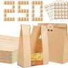 A set of kraft bakery bags with clear windows and brown seal stickers displayed next to a stack of bags.