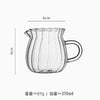 A clear glass milk pot designed for tea and espresso, shown from the side.
