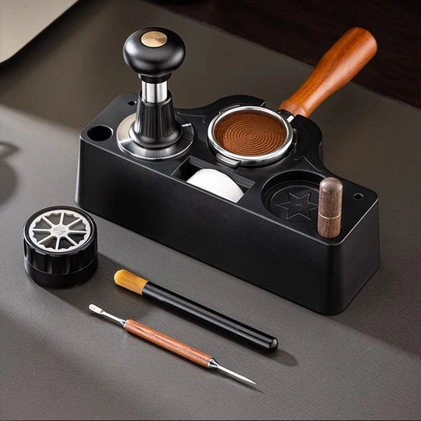 A black universal coffee tamper base with a wooden handle and a metal coffee puck, alongside a small metal tool.