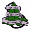 A green leaf enamel pin featuring the text Not idly do the leaves of Lörien fall.