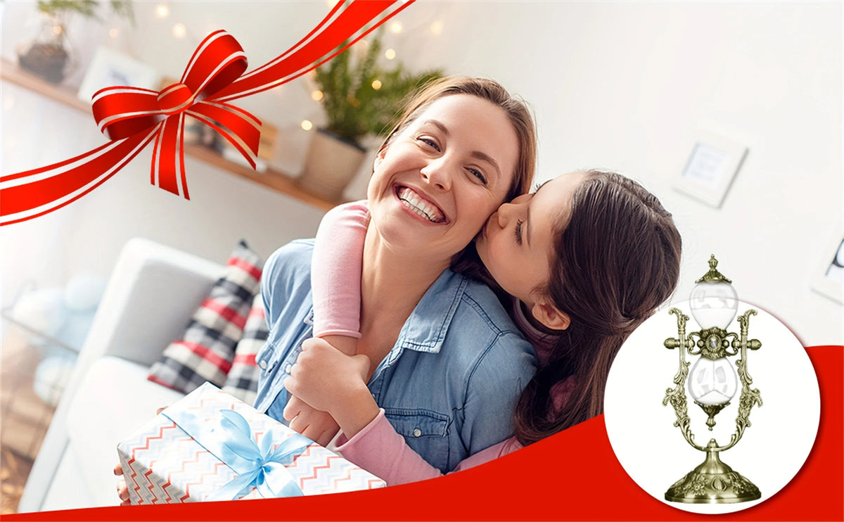 A smiling woman is affectionately kissing a young girl while holding a gift box, set against a bright indoor background.