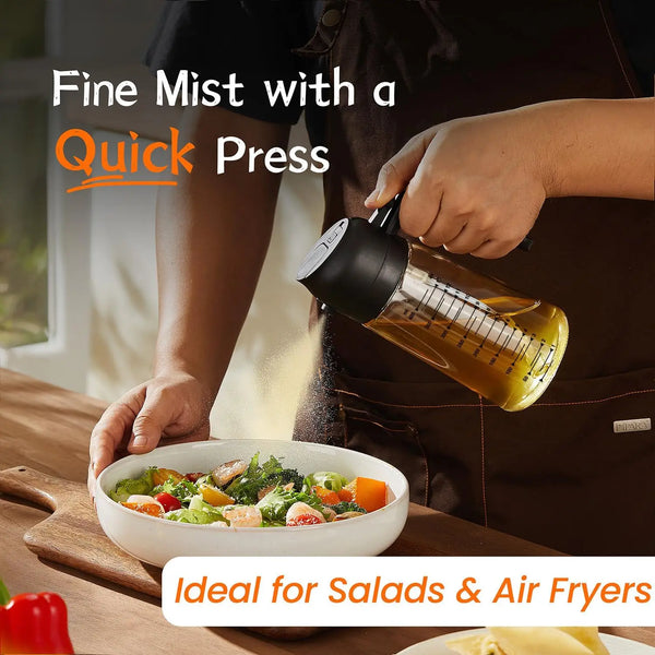 Eine Hand verwendet einen Glas-Olivenöl-Sprühbehälter, um Salate und Airfryer zu besprühen.