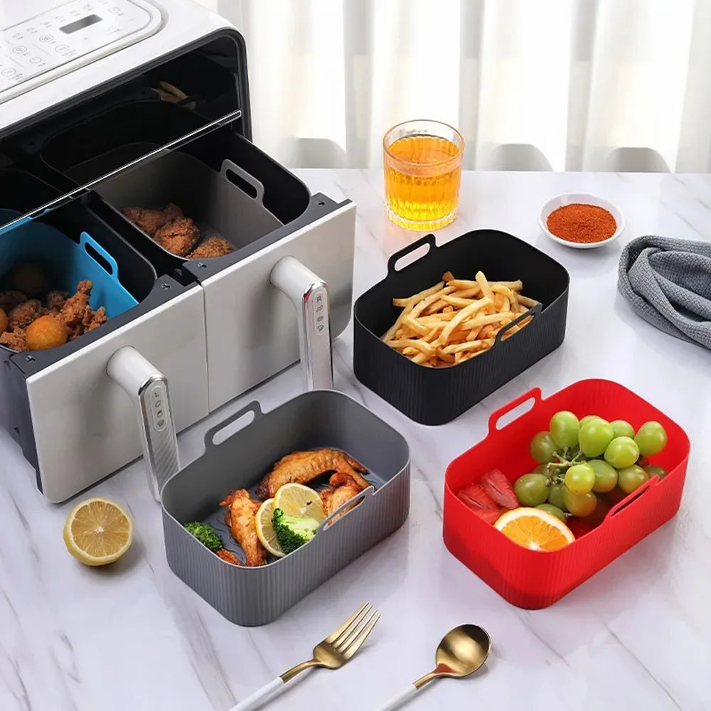 A collection of reusable silicone air fryer basket liners, including various colors and shapes, displayed on a white surface.