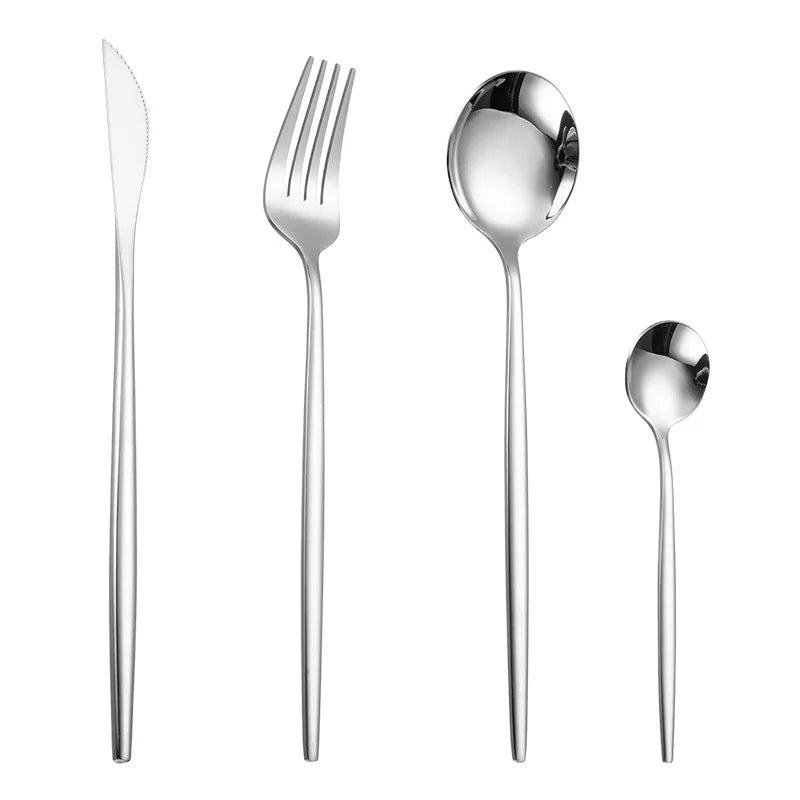 A set of four gold flatware pieces including a knife, fork, spoon, and another utensil.