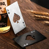 A set of stainless steel bottle openers featuring playing card designs on a wooden surface.