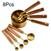 A set of eight stainless steel measuring spoons and cups with wooden handles.