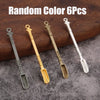 Six pieces of random color metal mini shovels and spoons displayed on a wooden surface.