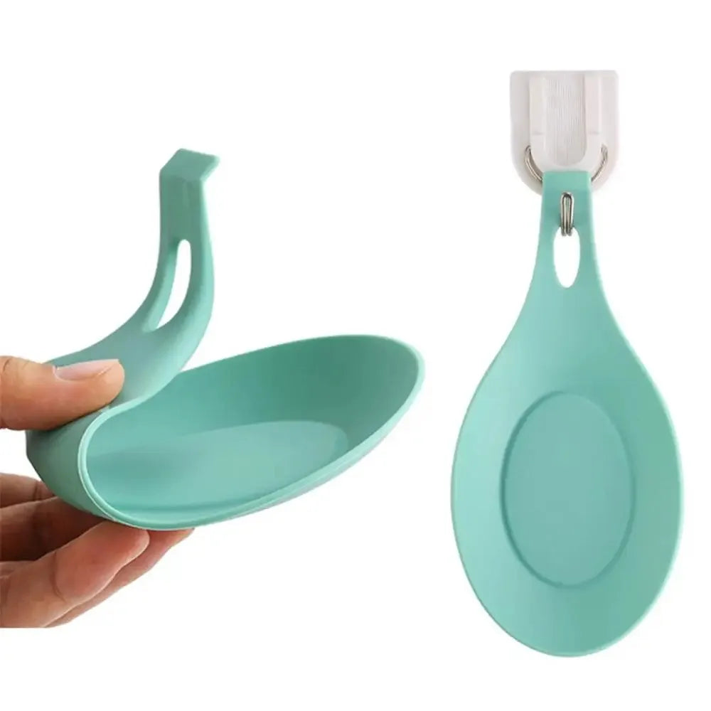 A teal silicone kitchen utensil holder with a hanging rack and a large oval spoon bowl.