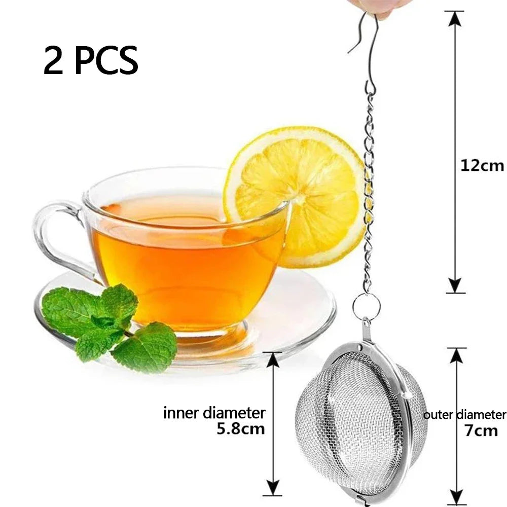 Two stainless steel mesh tea infusers with hooks and a lemon slice are shown.