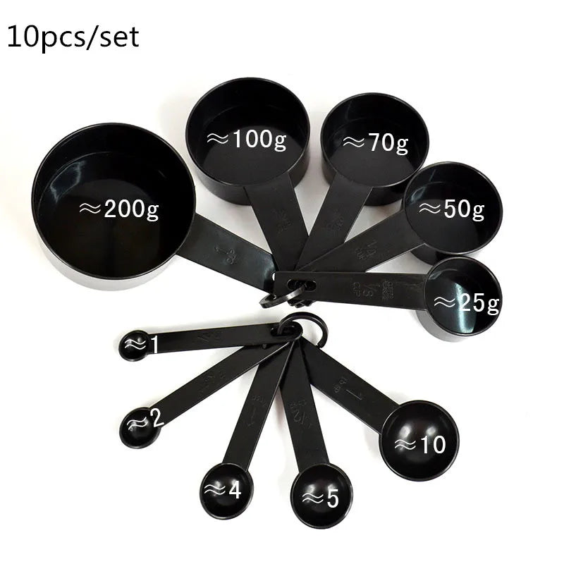 A set of black precision kitchen measuring spoons and cups with various weight markings