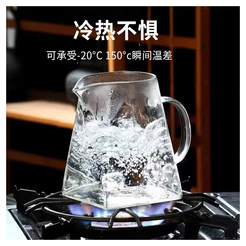 A clear glass teapot is heating on a stove, demonstrating its ability to withstand temperatures up to 150°C.