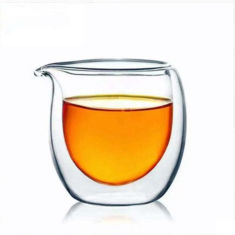 A clear double-wall glass tea pitcher filled with amber-colored liquid.
