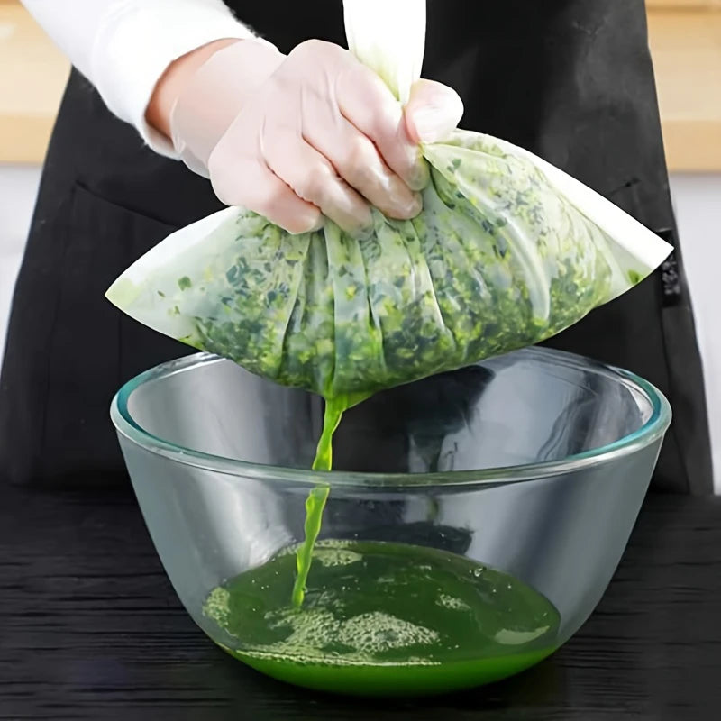 A hand is pouring a green liquid from a mesh strainer into a glass bowl.