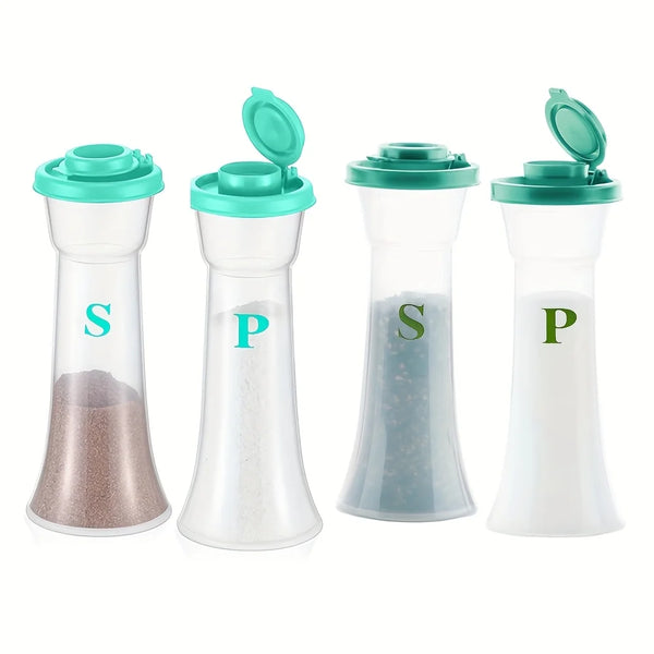Set klare Glassalz-und-pfeffermörser mit grünen Deckeln, die verschiedene Gewürze zeigen.