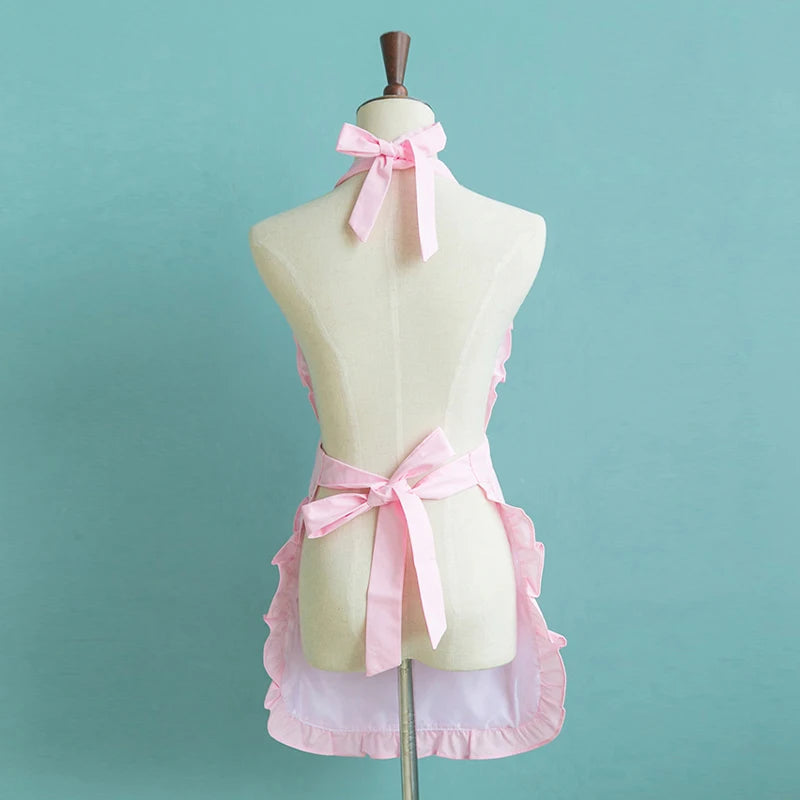 Pink princess heart bow apron displayed on a mannequin, featuring pink fabric and ties.