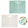 A light mint green silicone collapsible dish drying mat with a textured, ribbed pattern.