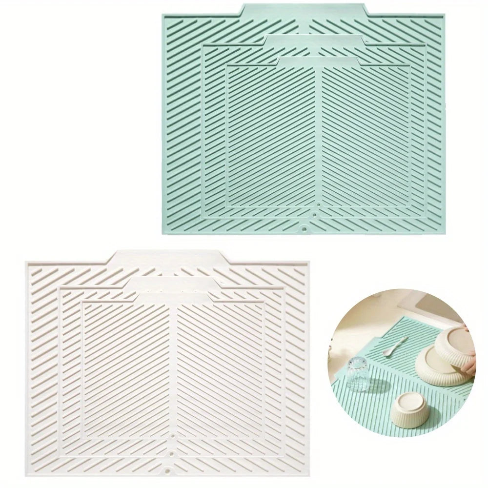 A light mint green silicone collapsible dish drying mat with a textured, ribbed pattern.