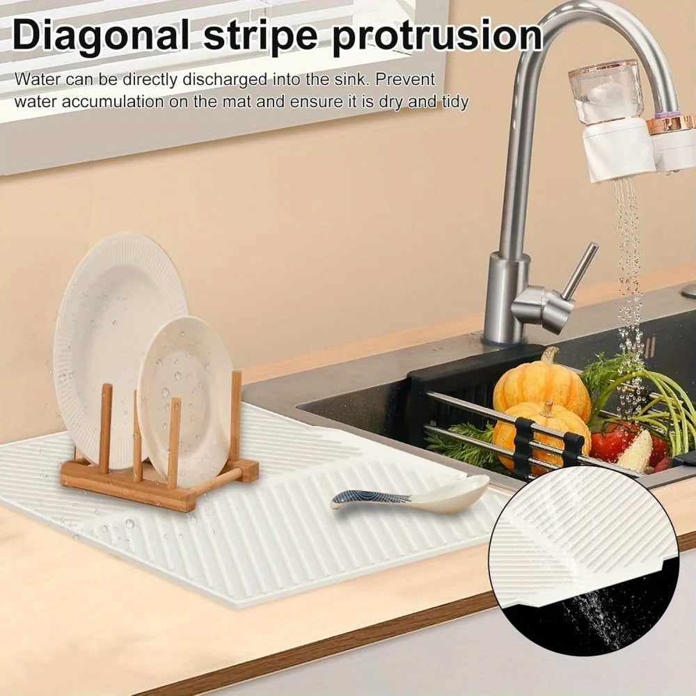 A silicone collapsible dish drying mat is shown next to a kitchen sink with a faucet, demonstrating water drainage.