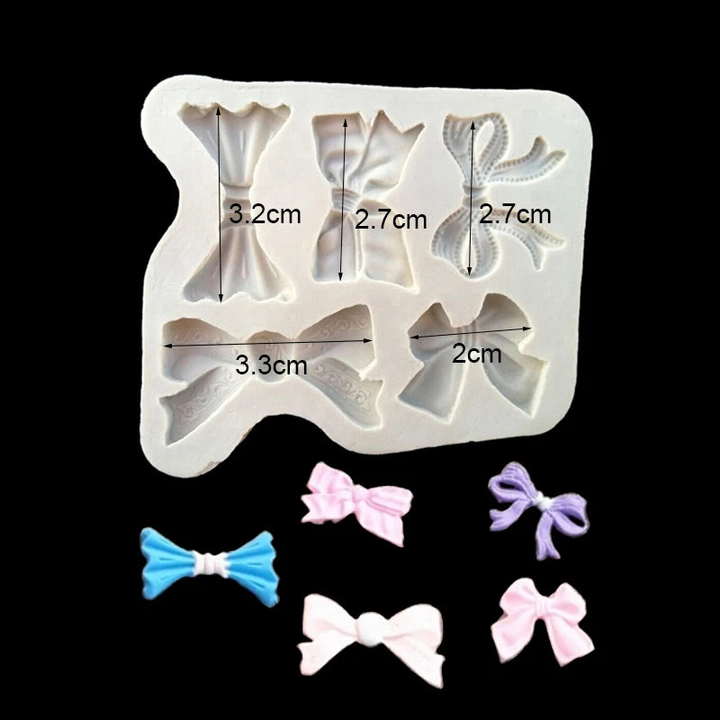 A set of silicone baking molds shaped like bows and flowers for chocolate cupcakes.