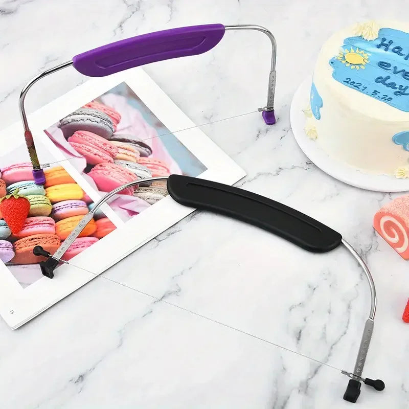 A set of adjustable stainless steel cake slicers and knives, purple and black, resting on a white marble surface.