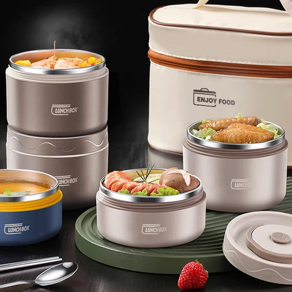 A set of insulated stainless steel lunch boxes in beige and gray colors with food inside