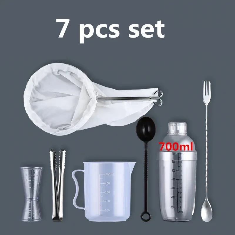 A set of seven plastic cocktail tools including a shaker, strainer, measuring cups, and spoons.