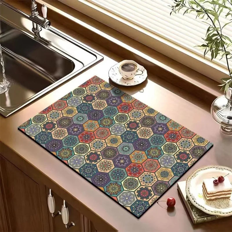 A hexagonal retro bohemian absorbent dish drying mat with a colorful pattern rests on a kitchen counter.