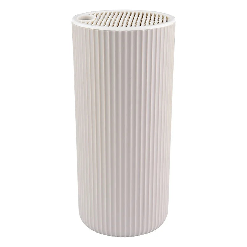 A cylindrical white knife block organizer with vertical ribbed texture.