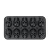 A black silicone mold tray with twelve skull-shaped cavities for making ice cubes.