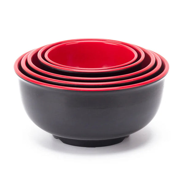 A stack of red melamine soup and rice bowls with a black base.