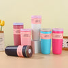 A collection of pink and blue vacuum insulated coffee mugs displayed on a light surface.