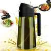 A black 2-in-1 light-blocking olive oil dispenser bottle with a green liquid being poured onto a surface.