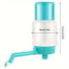 A teal manual bucket water pump dispenser with a white body and a flexible tube.