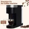 A black precision fit coffee machine is shown with a glass mug filled with brewed coffee and loose coffee beans nearby.