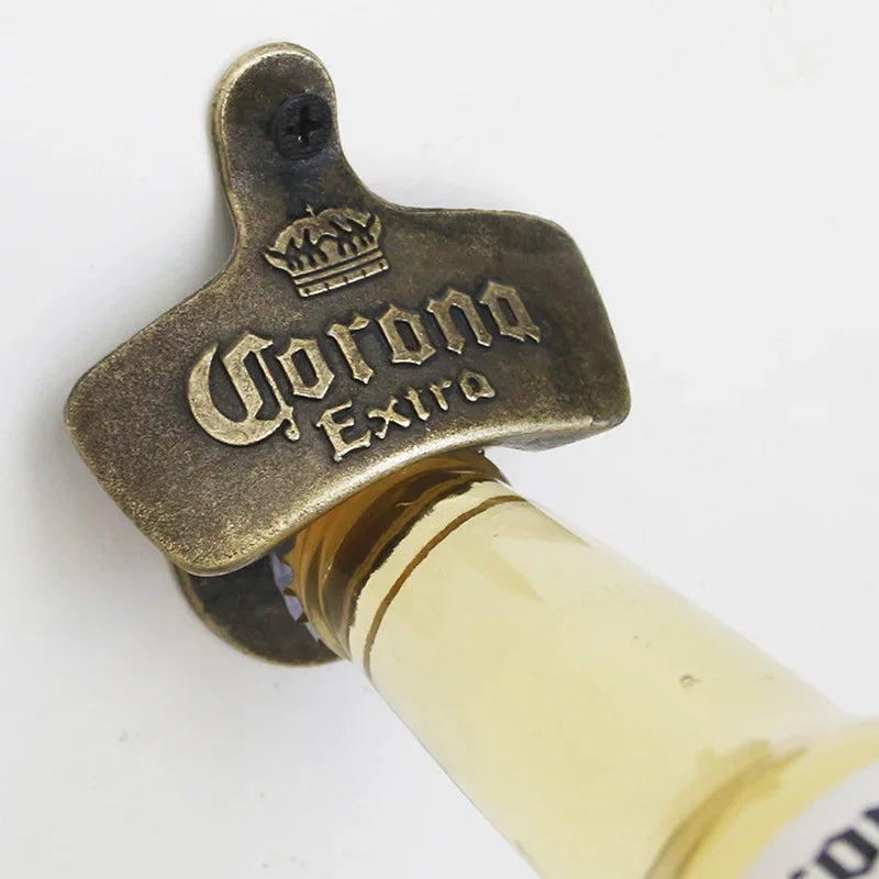 A brass bottle opener shaped like a crown with the word Corona Extra engraved on it.