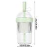 Clear reusable tumbler coffee cup with a light green straw lid and a measuring scale.