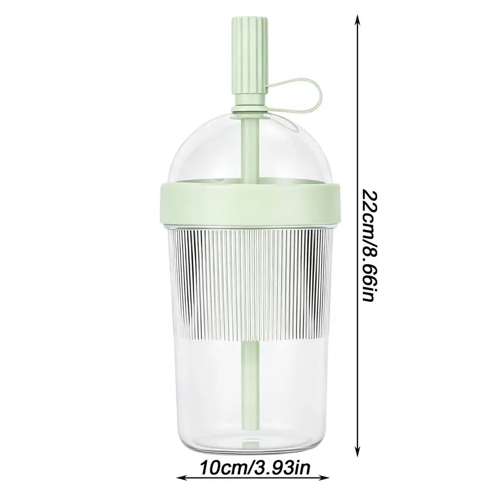 Clear reusable tumbler coffee cup with a light green straw lid and a measuring scale.