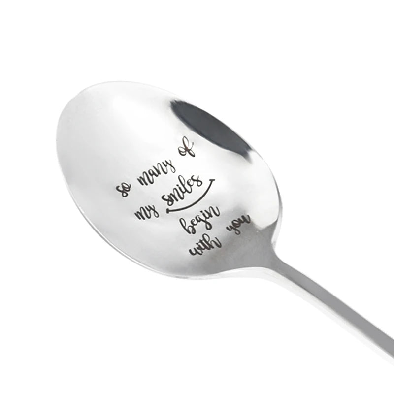 A silver stainless steel spoon engraved with the message so many of my smiles begin with you
