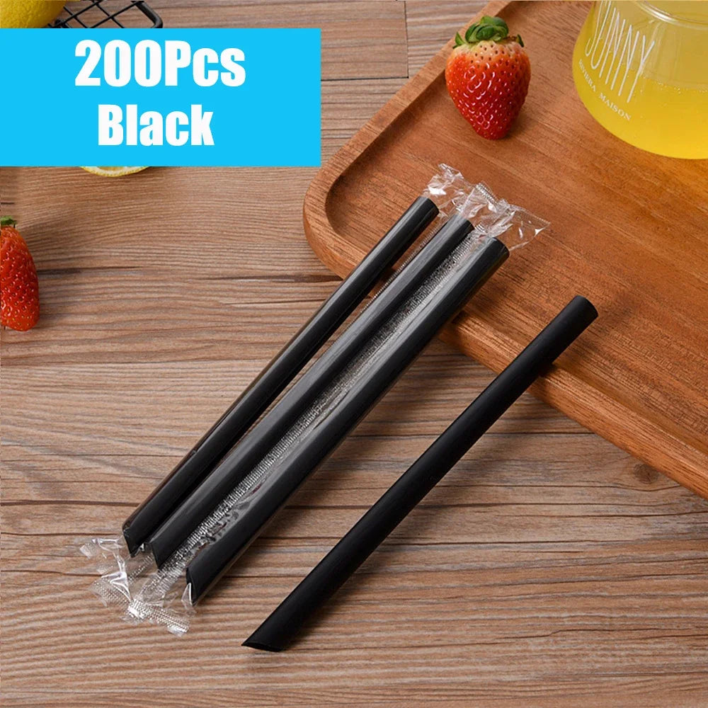 A set of 200 black reusable plastic drinking straws packaged in clear plastic on a wooden board.
