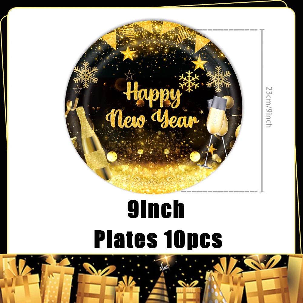 A black plate decorated with gold glitter, snowflakes, and a champagne bottle for a New Year celebration.