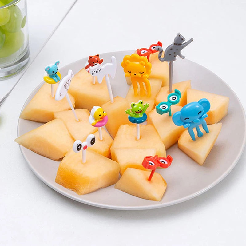 A plate of cute fruit and dessert picks featuring various animal-shaped food items for kids