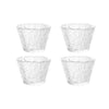 Four clear glass tea cups or bowls arranged in a square formation.