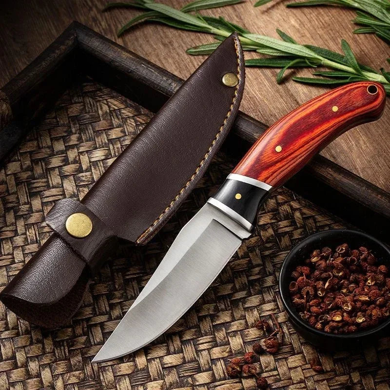 A stainless steel survival knife with a wooden handle rests on a woven mat next to some dried spices.
