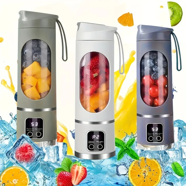A portable handheld juicer blender in gray and white is shown with various fruits and vegetables around it.