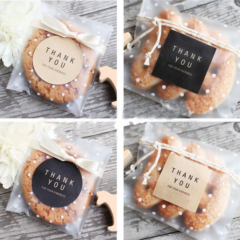 Several round, golden cookies are packaged in clear cellophane bags tied with natural twine and a thank you tag.